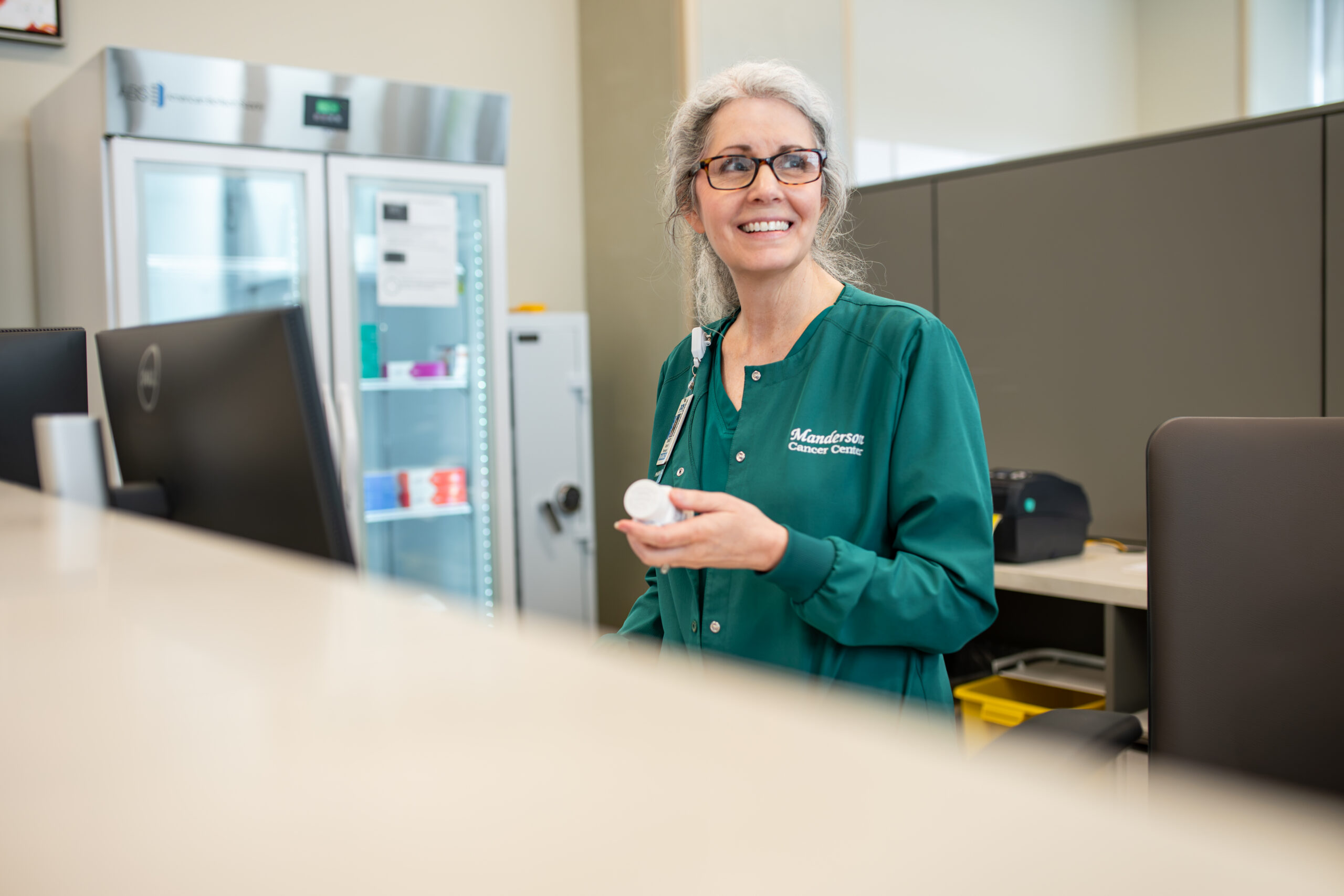 DCH Pharmacist holding a bottle of medicene.
